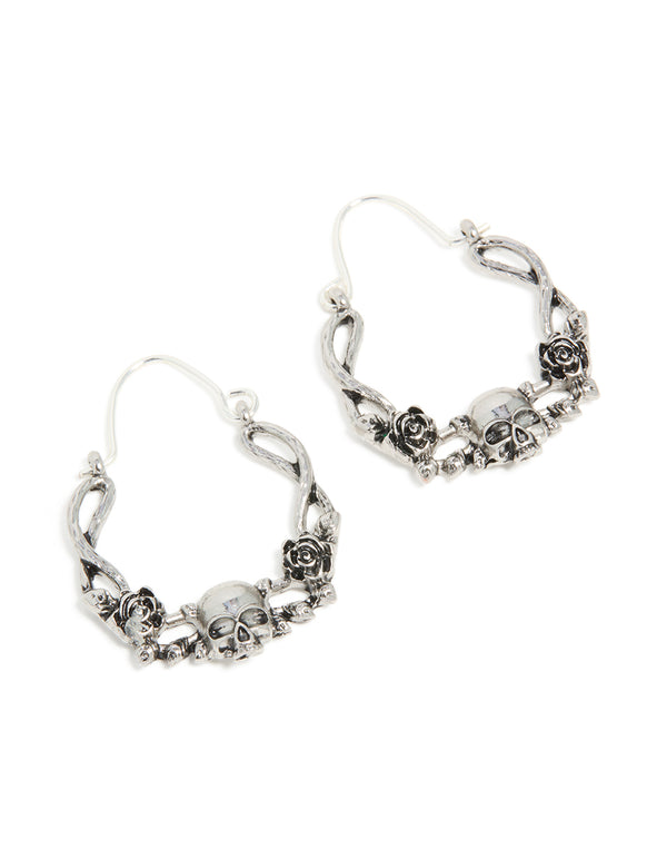 Showcasing statement hoop earrings with skull featuring with floral pattern in silver front view
