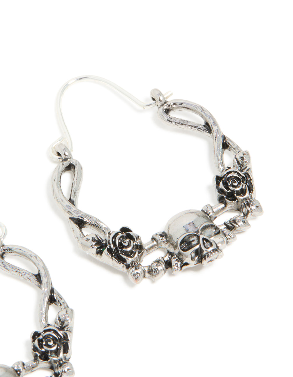 Highlighting statement hoop earrings with skull featuring floral pattern in silver post detail view