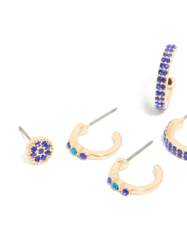 Featuring gold diamante evil eye and cross earrings in a 5-pack, hoop and stud closures in blue and aqua tones close up view