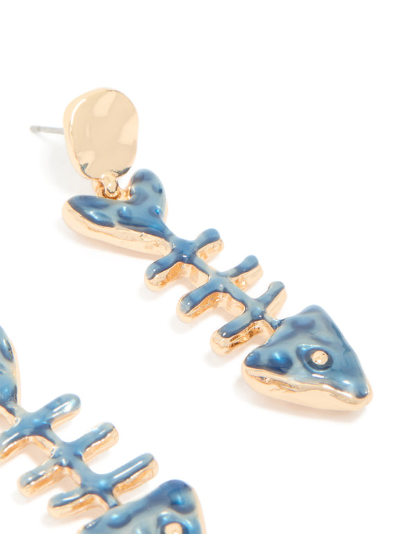 Highlighting gold blue fish skeleton drop earrings with ocean theme details in steel post detail view