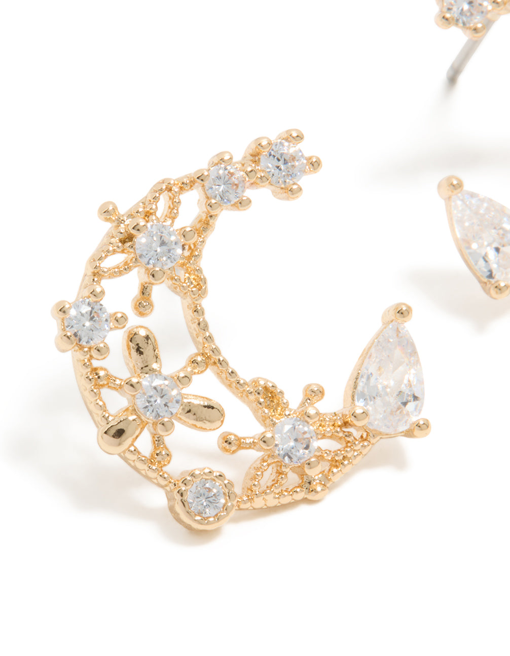 Featuring dainty celestial moon stud earrings in gold with cubic zirconia close up view