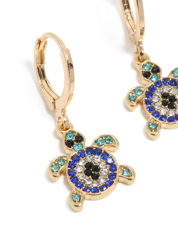 Detailed view of gold blue diamante turtle huggie earrings with turquoise and black ocean-inspired design in a close up view