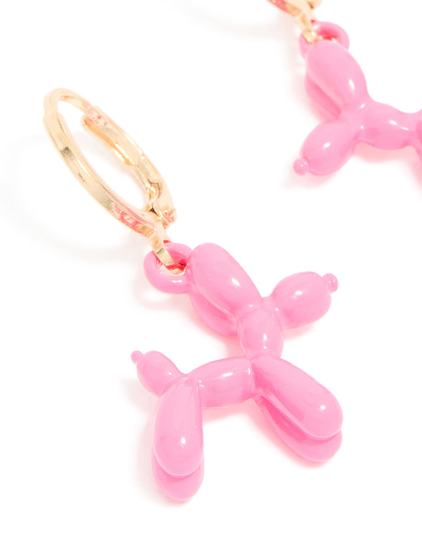 Crafted with animal design these pink balloon dog huggie earrings in gold close up view