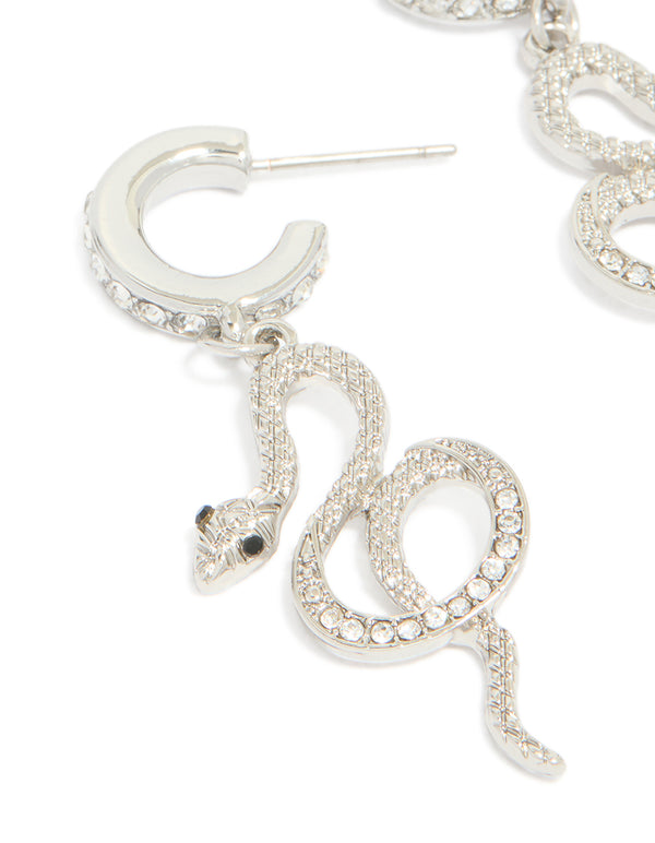 Featuring silver diamante snake huggie earrings in statement style close up view