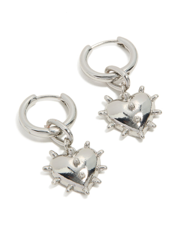 Showcasing statement huggie earrings with heart detail in silver front view