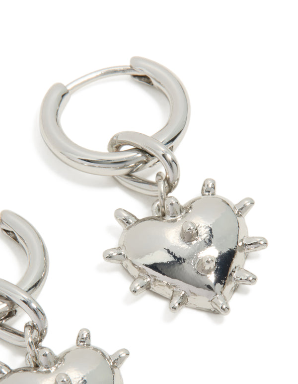 Designed with heart and spikes, these statement silver huggie earrings offer versatile styling post detail view