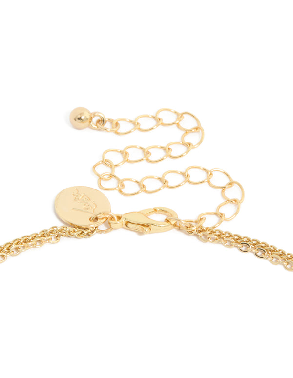 Highlighting a gold plated cubic zirconia layered necklace with infinity and cross clasp detail view