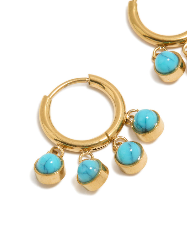 Featuring chunky huggie earrings with charm details, crafted from waterproof stainless steel and turquoise in gold plating close up view