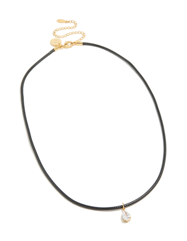 Crafted from waterproof gold plated stainless steel and black cord necklace with pear cut cubic zirconia pendant in crystal close up view