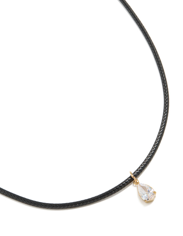 Featuring a waterproof necklace crafted from gold plated stainless steel with black cord with pear cut cubic zirconia pendant in crystal front view