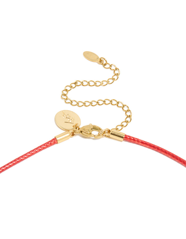Featuring a pear cut crystal cubic zirconia waterproof gold plated stainless steel pendant necklace on coral red cord clasp detail view