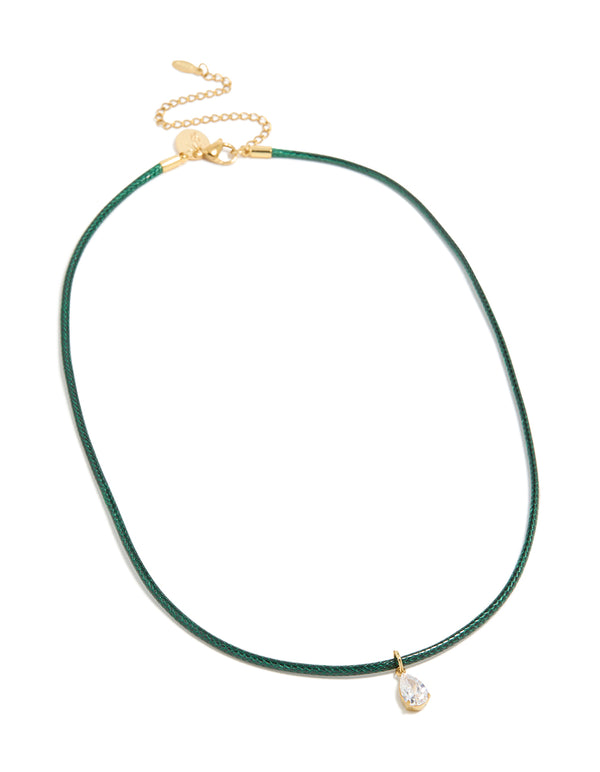 Displaying a waterproof necklace with pear cut cubic zirconia pendant on dark green cord, crafted from gold plated stainless steel and crystal front view
