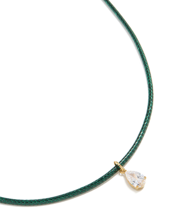 Showcasing a waterproof necklace with pear cut cubic zirconia pendant on dark green cord, crafted from gold plated stainless steel and crystal close up view