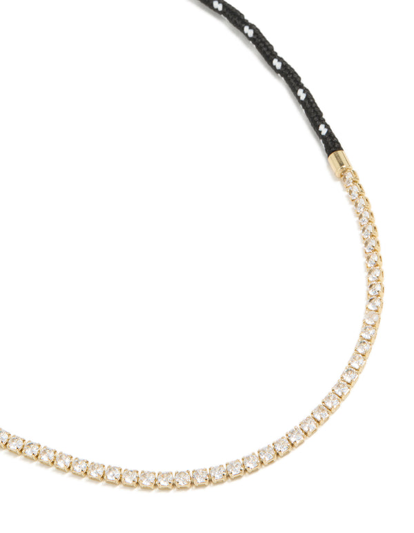 Showcasing a waterproof tennis necklace crafted from gold plated stainless steel with black cord, designed in a statement style close up view