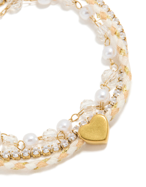 Showcasing waterproof gold plated stainless steel pearl, cord and tennis bracelet featuring beads, heart and pearl, cubic zirconia in dainty style close up view