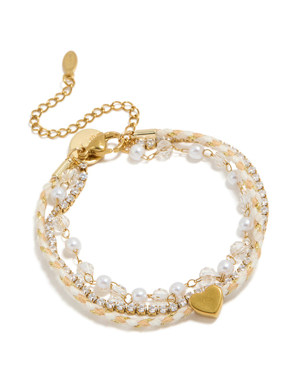 Elegantly designed waterproof gold plated stainless steel pearl, cord and tennis bracelet featuring beads, heart and pearl, cubic zirconia in dainty style front view