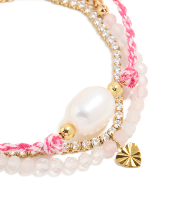 Featuring waterproof stainless steel tennis bracelet with heart, beads, cubic zirconia, cord, and freshwater pearl accents in pink, white, and gold plated finish close up view