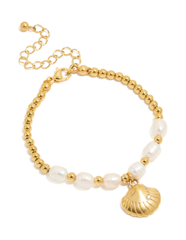 Showcasing a waterproof gold plated stainless steel freshwater pearl and shell ,ball bracelet with beads, ocean accents and statement styling front view