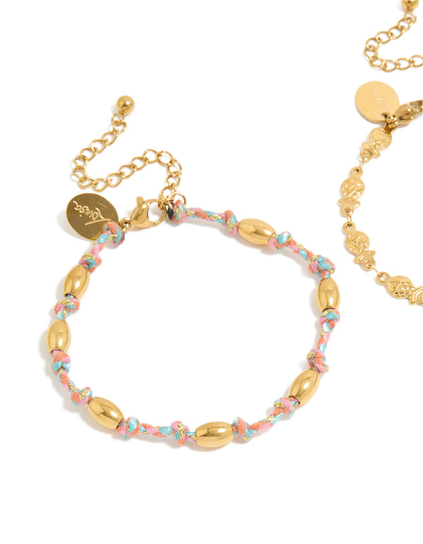Detailed view of waterproof bracelets in a 2-pack with ocean accents, crafted from stainless steel, one featuring beads on pink and blue cord and one in gold plated finish close up view