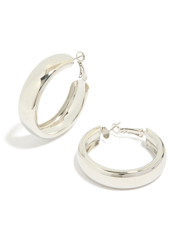 Showcasing chubby flat hoop earrings in silver with chunky styling and closure front view