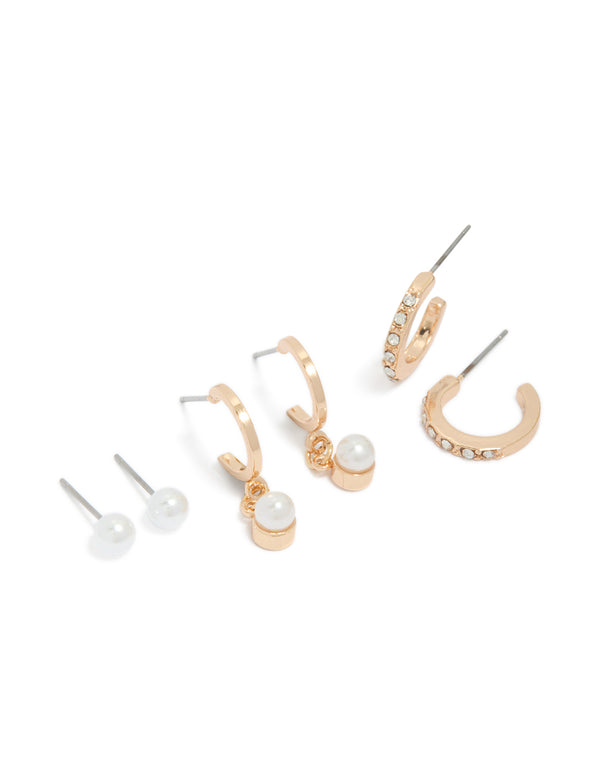 Showcasing dainty gold pearl and diamante huggie earrings in a 3-pack with stud closure front view