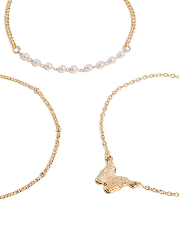 Showcasing gold butterfly charm and pearl bracelets in a 3-pack close up view