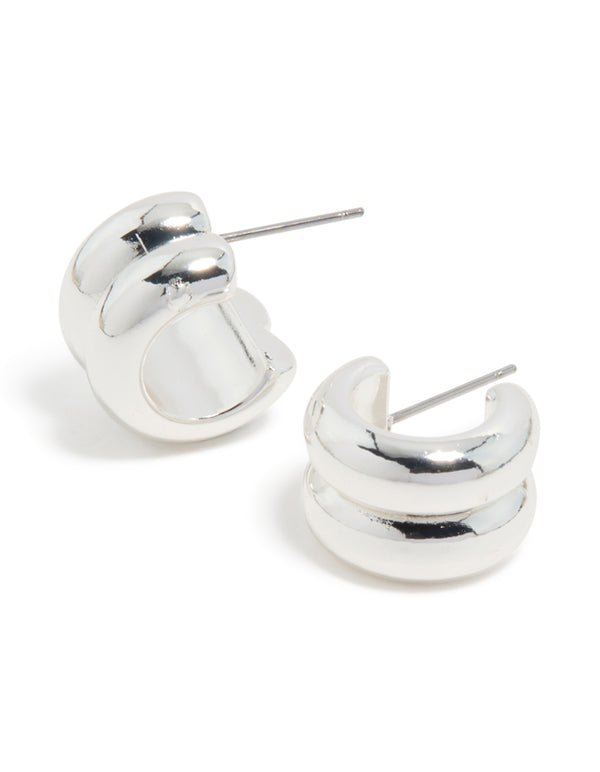 Showcasing chunky ribbed huggie earrings in silver with front view