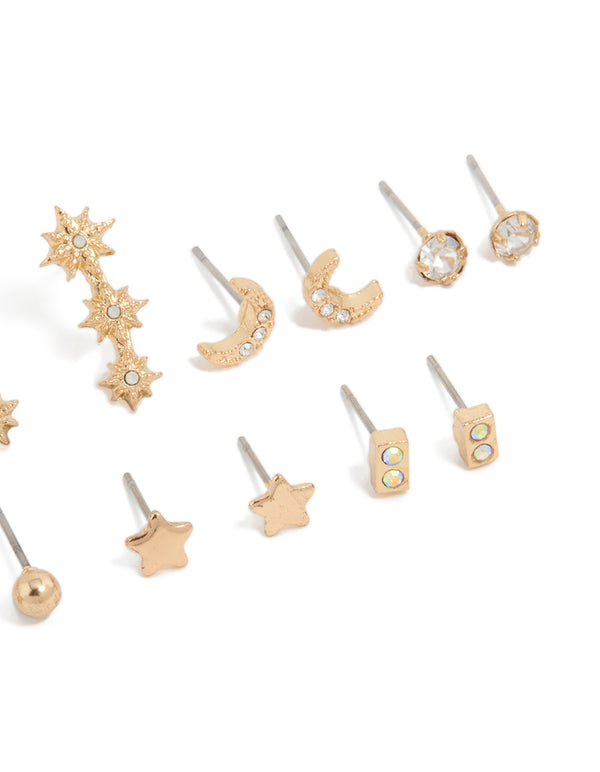 Showcasing gold diamante earrings 7-pack featuring ball star and moon designs with glitter accents and stud closure close up view