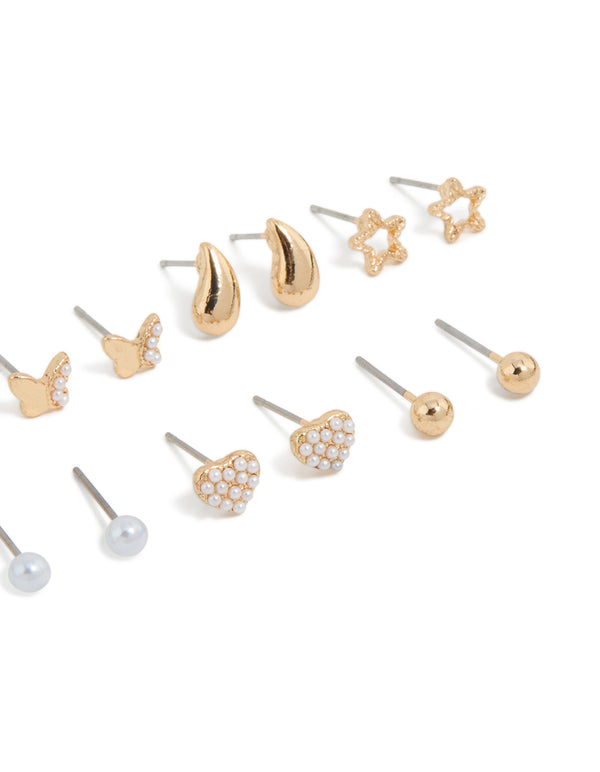Designed with mini stud earrings featuring bow, celestial star, ball, heart, and pearl accents in gold 7-pack post detail view