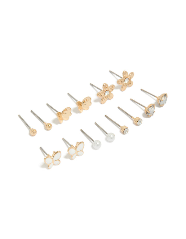 Discover a 7-pack of gold stud earrings featuring butterfly, ball and floral designs with pearl and enamel crafted from enamel front view