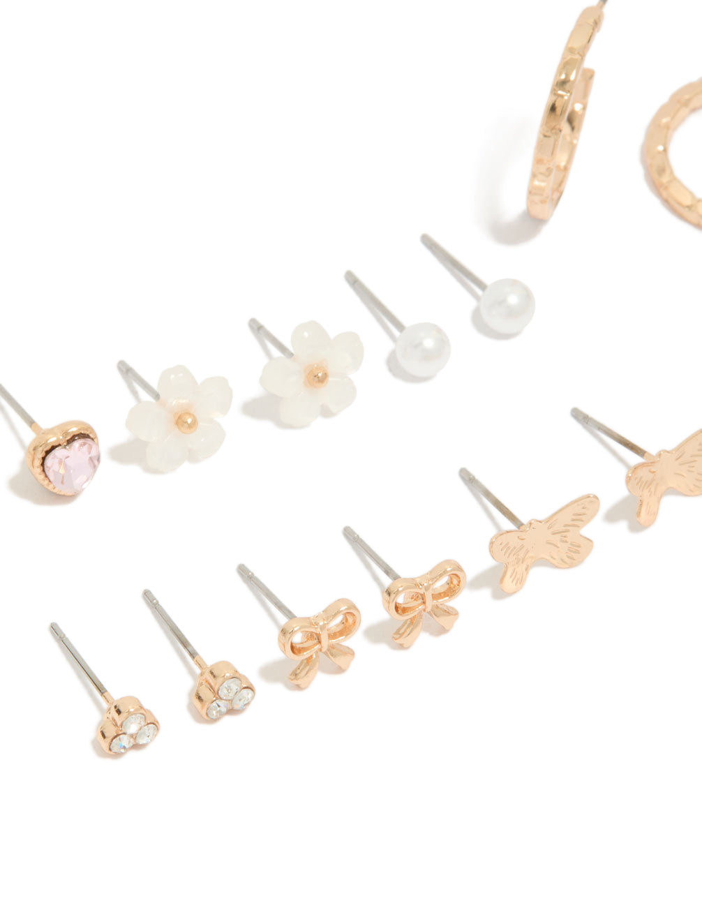 Crafted gold earrings 8-pack featuring bow, heart, pearl and butterfly details with stud and hoop closure in ivory, pink, and silver accents close up view