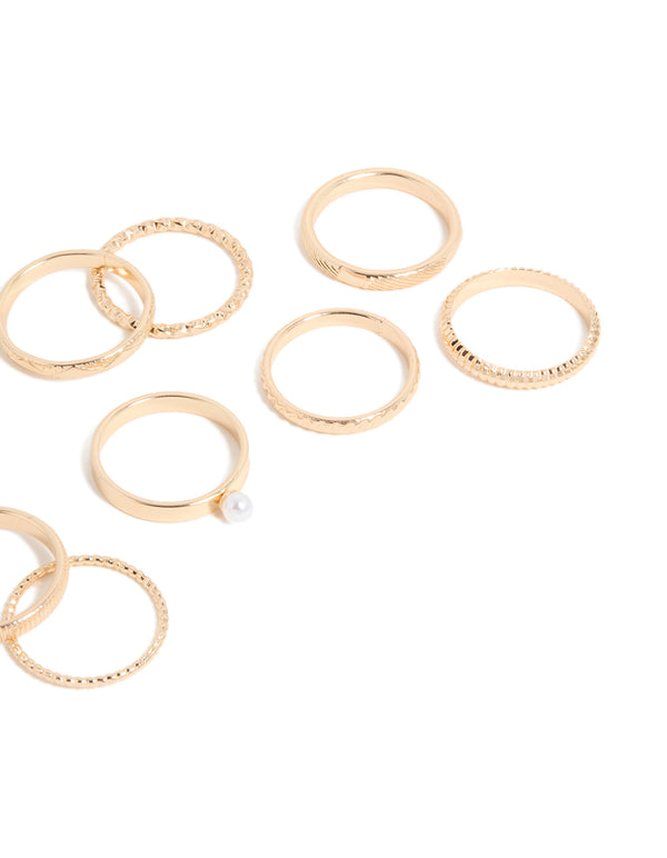 Showcasing simple pearl and textured rings 10-pack in gold with stackable statement design close up view