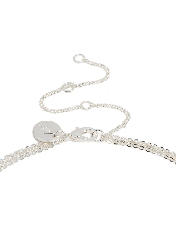 Showcasing silver plated bar and cross layered necklace with balls, beads designed in dainty style clasp detail view