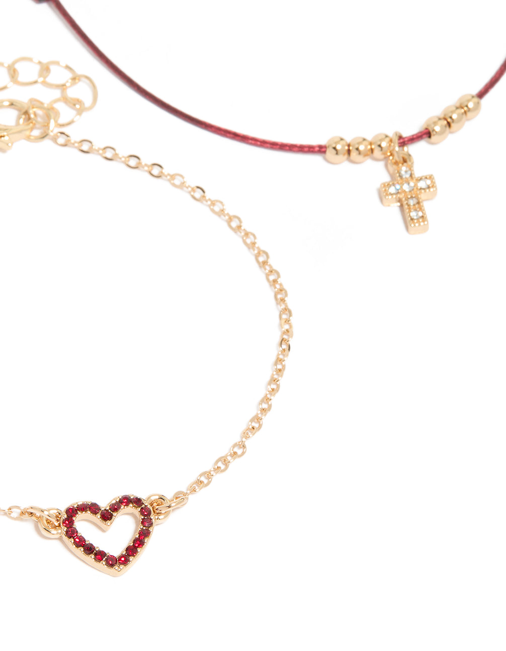 Crafted from burgundy cord cross and crimson heart in gold close up view