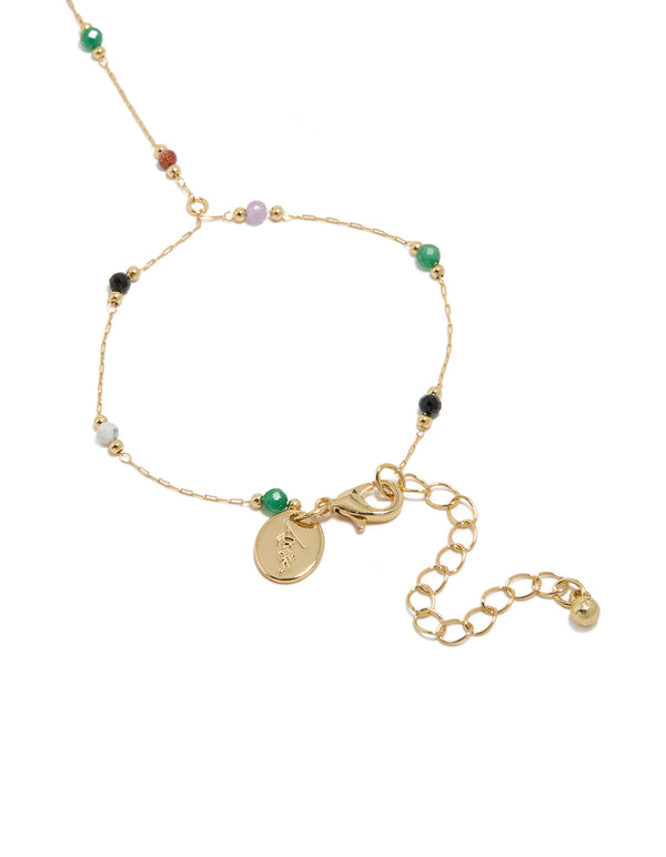Displaying a gold plated multicoloured semi precious stone beaded hand chain in statement style closure detail view