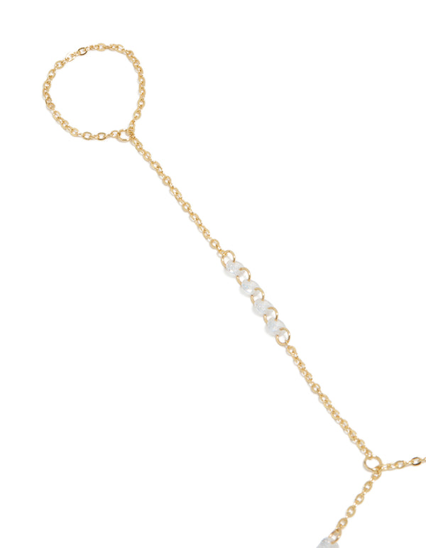 Showcasing gold plated floating cubic zirconia hand chain bracelet with featuring beads close up view