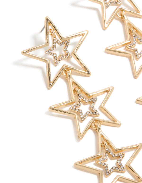 Discover these trio drop earrings featuring celestial star motifs in gold with white diamante embellishments close up view