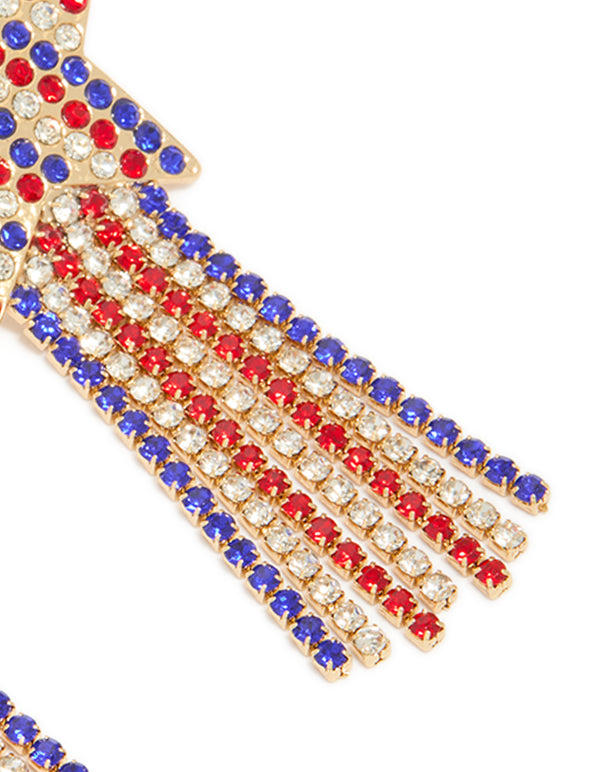 Crafted with gold red clear and blue diamante cup chain star drop earrings featuring celestial tassel design in statement style post detail view