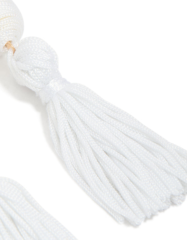Stunning white fabric tassel drop earrings showcasing statement style and gold detailing post detail view