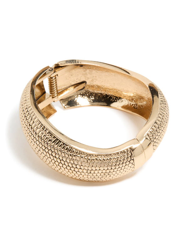 Showcasing a gold dotted boho hinged statement bangle front view