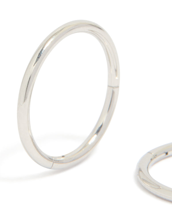 Displaying statement chunky surgical steel sleeper hoop earrings in silver close up view