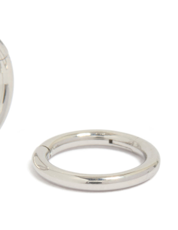 Featuring chunky surgical steel 6 mm thick sleeper hoop earrings in silver from an alternate angle post detail view