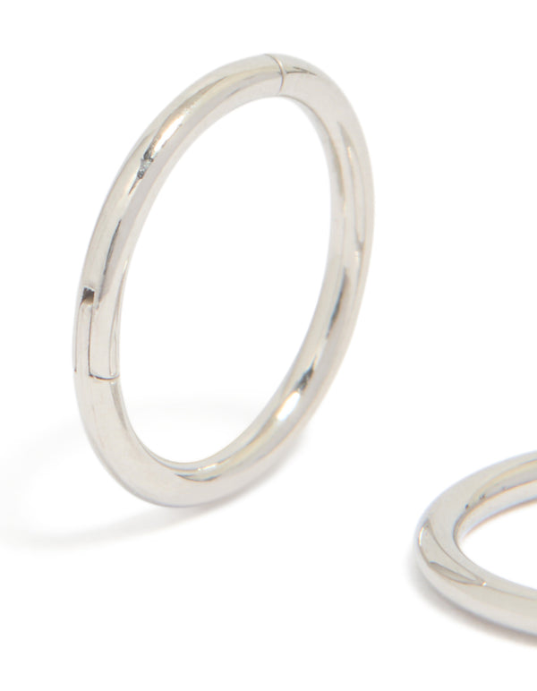 Featuring surgical steel 8 mm thick sleeper hoop earrings in silver with chunky styling close up view