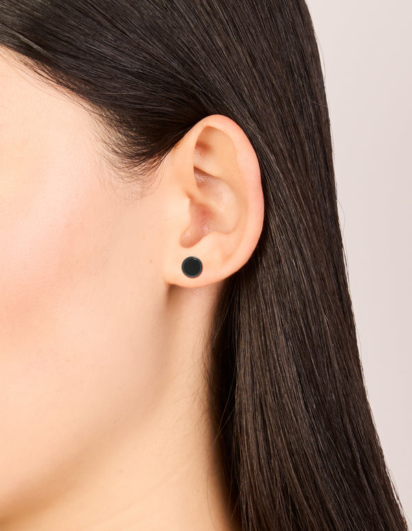 Featuring black coated surgical steel disc flat back studs in minimalist design on ear view