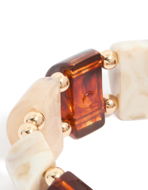 Crafted with alternating rectangular acrylic beads in brown cream featuring gold spacer balls details close up view