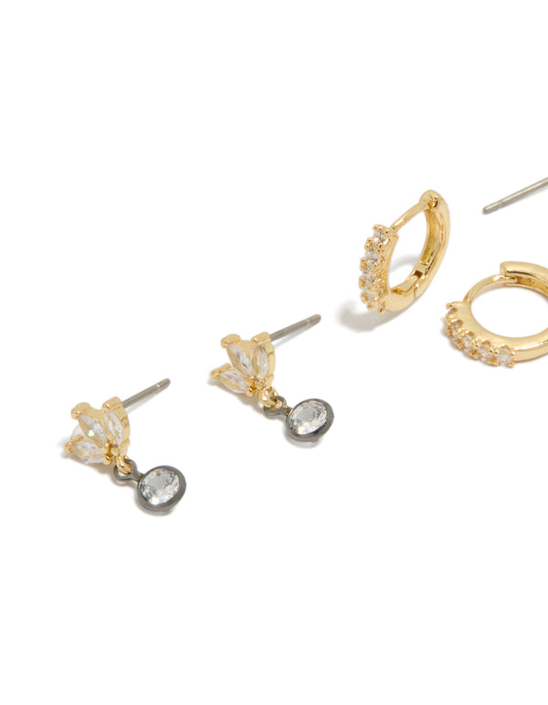 Showcasing mixed metal plated cubic zirconia bezel stud and huggie earrings in a 3-pack featuring gold, silver, and clear tones close up view