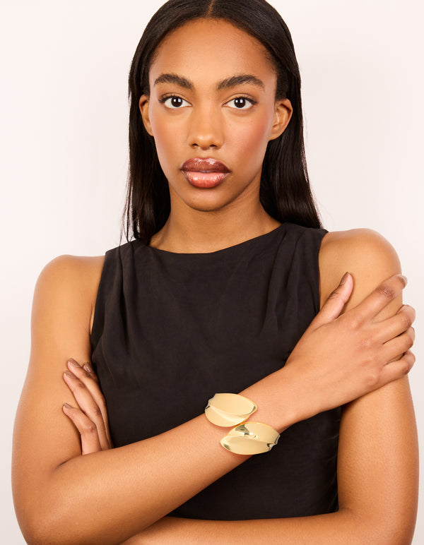 Elegant gold plated thick curved statement bangle on model view