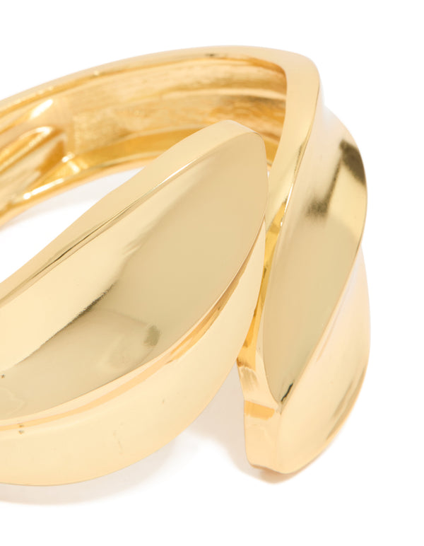 Crafted with gold plated metal thick curved statement bangle close up view