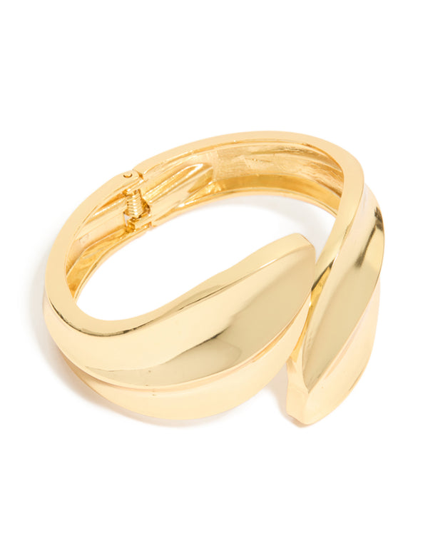 Showcasing gold plated thick curved bangle in statement style front view