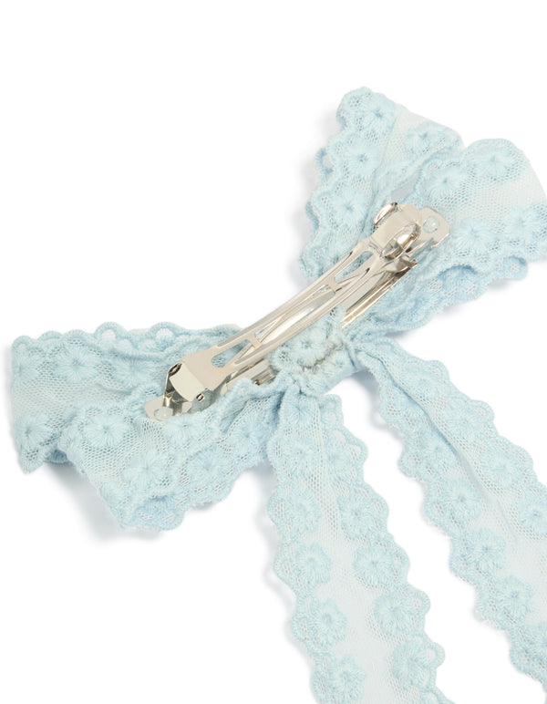 Featuring floral fabric bow hair clip in powder blue with metal clasp mechanism, side view